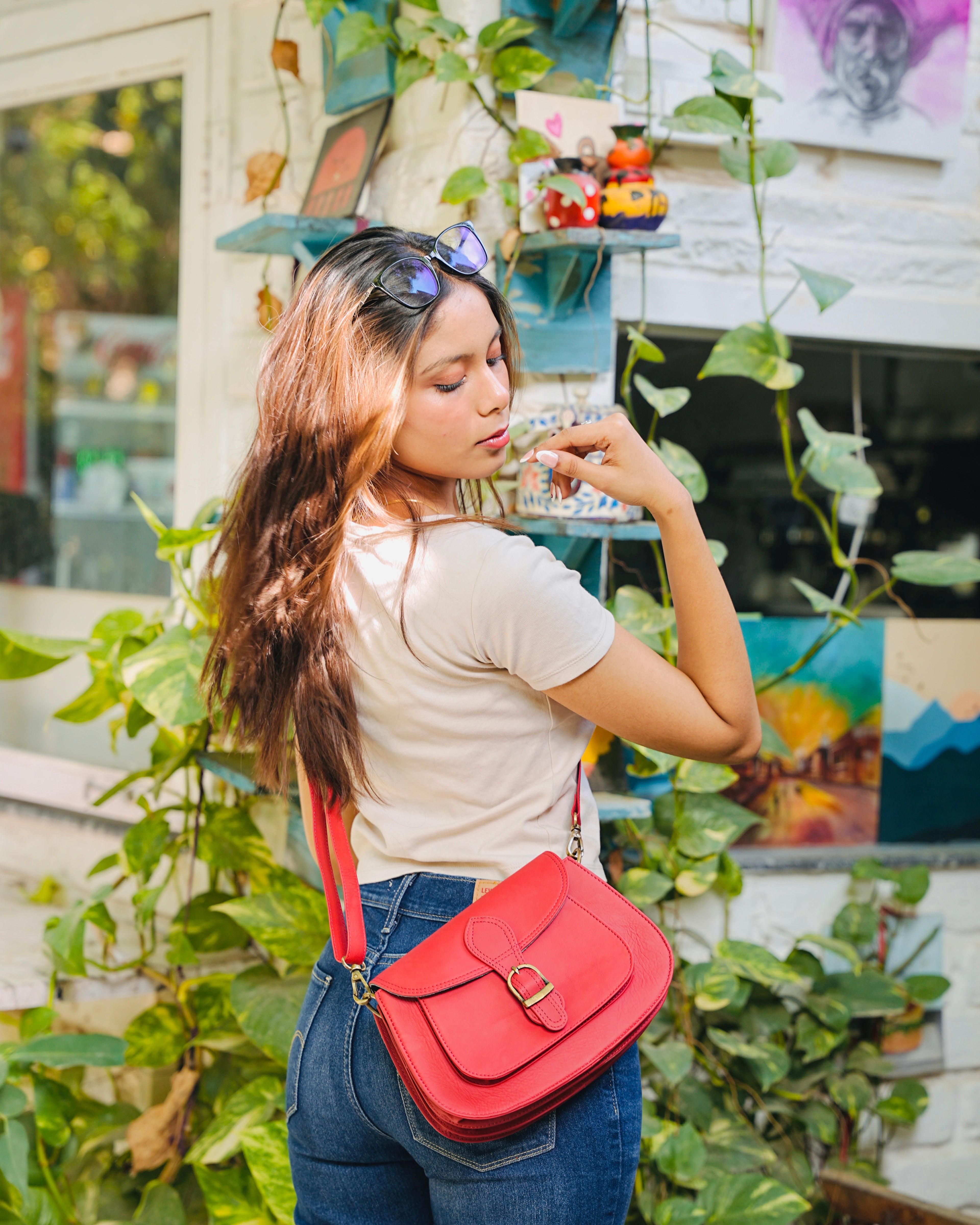 Red leather bag with gold buckle and a detachable strap and multipurpose and multi utility and 100% buffalo leather