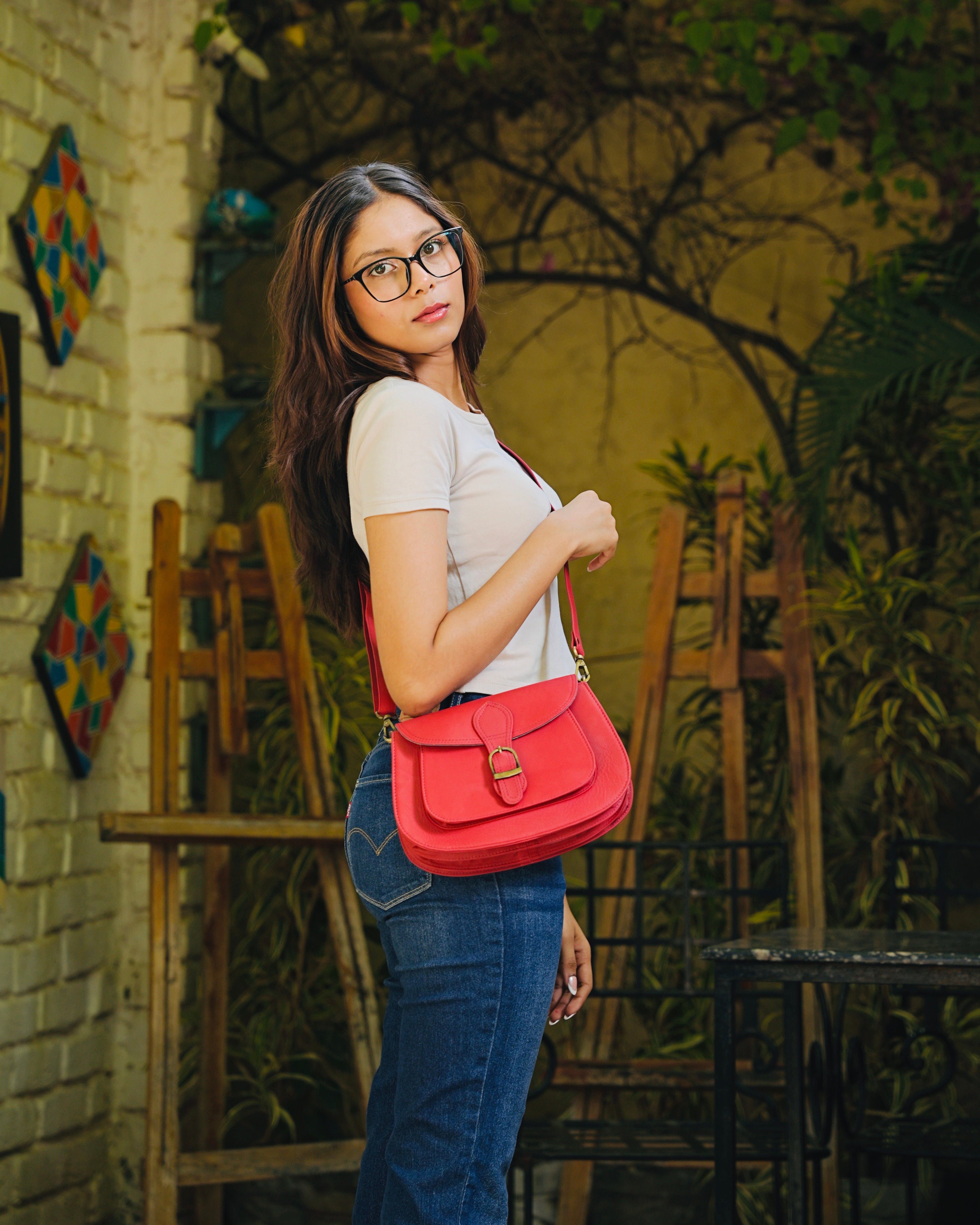 Red leather bag with gold buckle and a detachable strap and multipurpose and multi utility and 100% buffalo leather