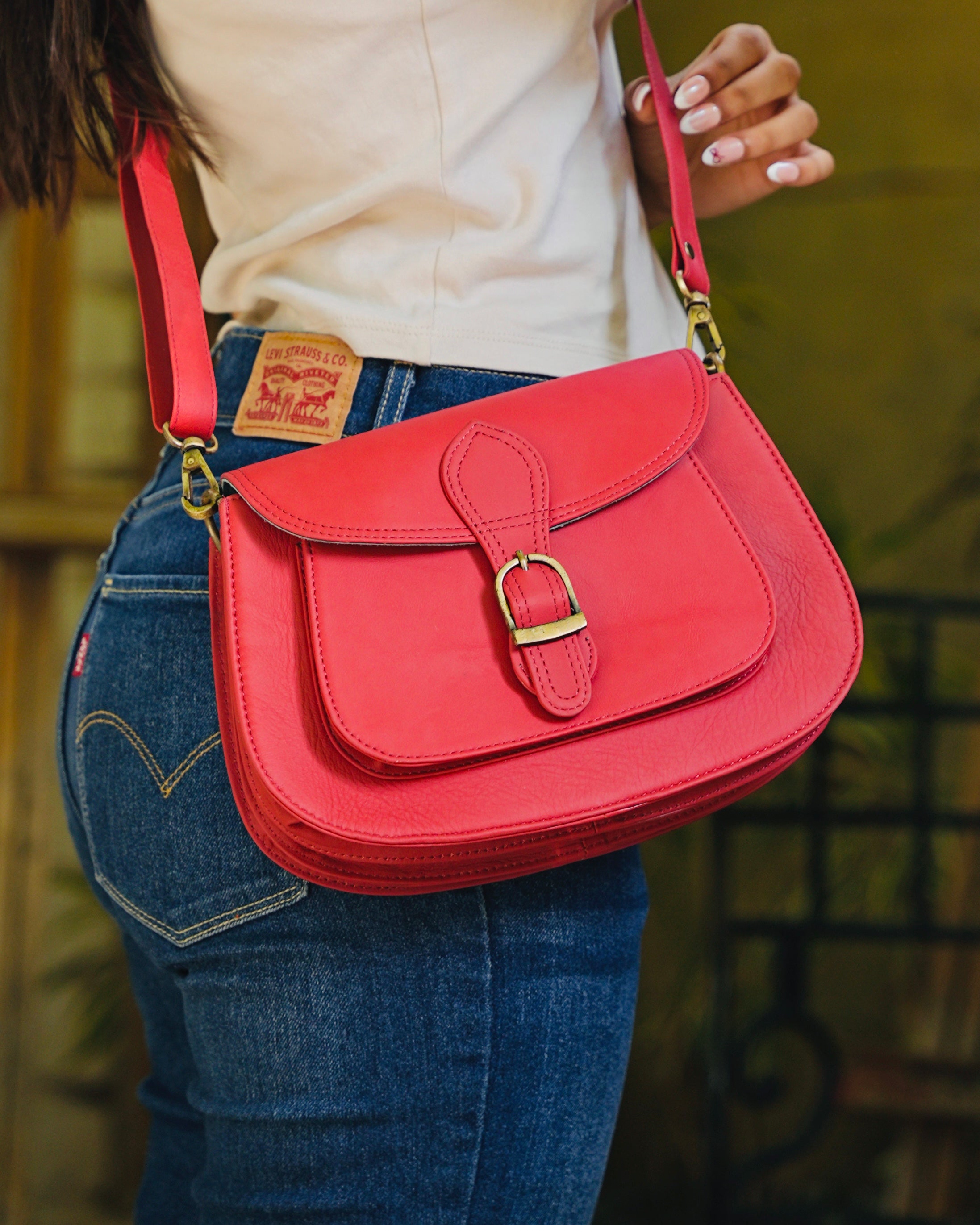 Red leather bag with gold buckle and a detachable strap and multipurpose and multi utility and 100% buffalo leather