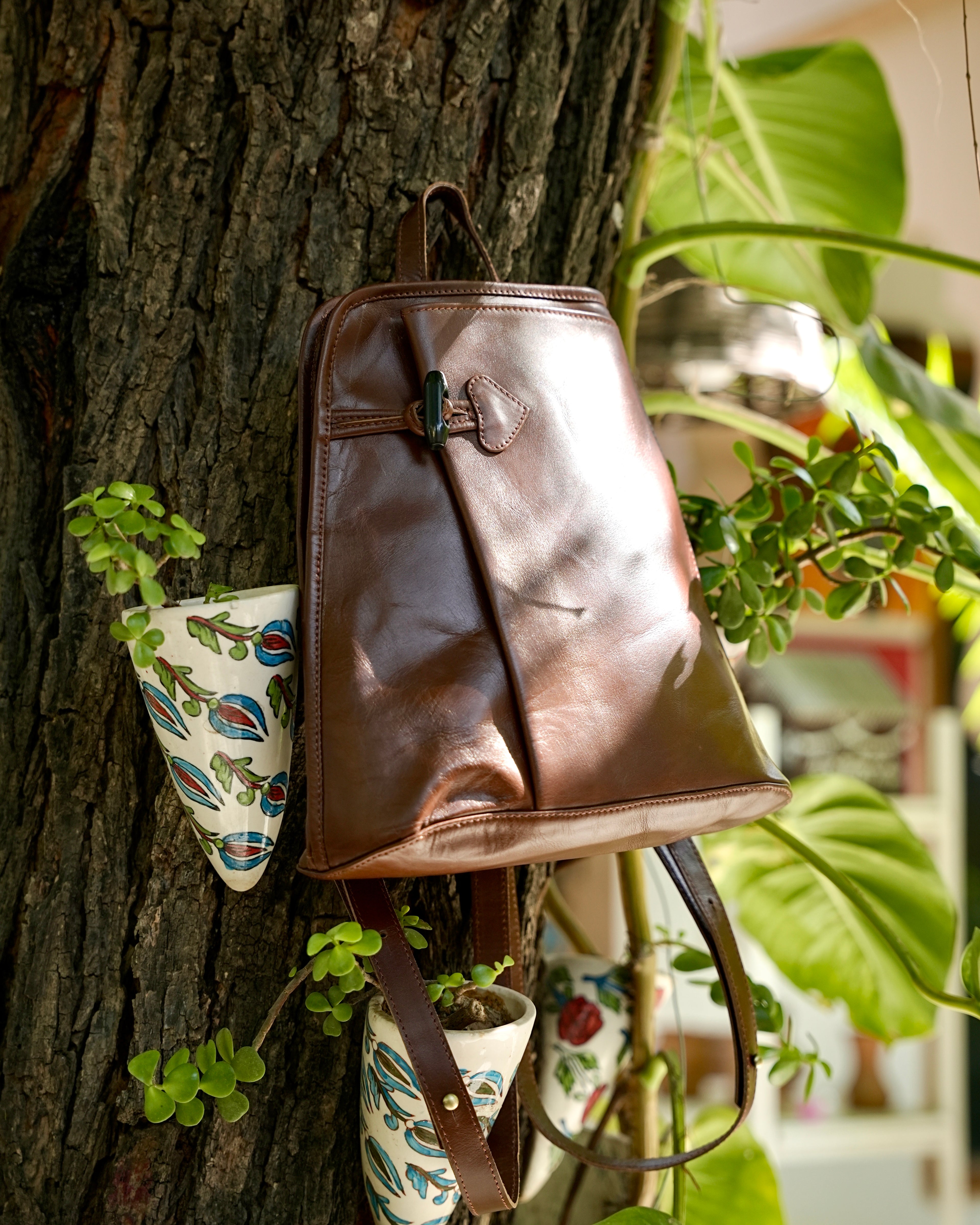 Person wearing a brown buffalo leather backpack with a aesthetic vibe 100% leather
